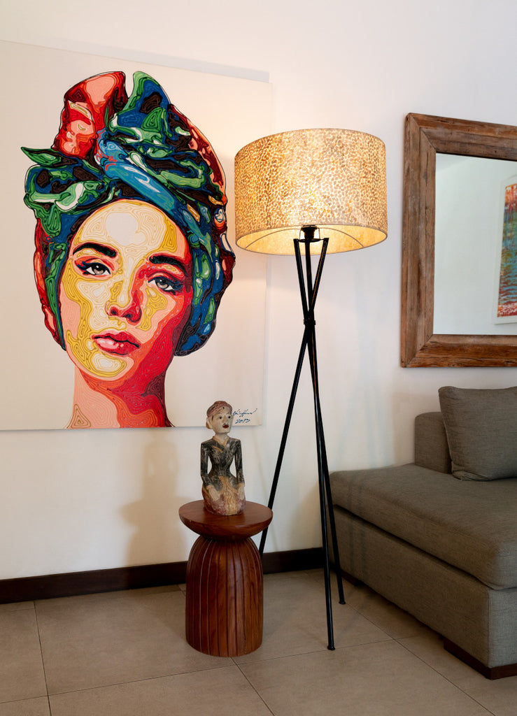 Wangi Gold Floor lamp with shade standing next to a colorful picture in a Balinese villa in Indonesia