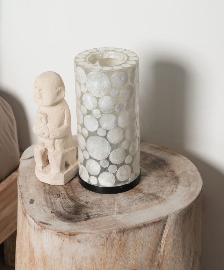 Table Lamp "White Coin Mini Cylinder" standing on a bedside table in a bedroom.
