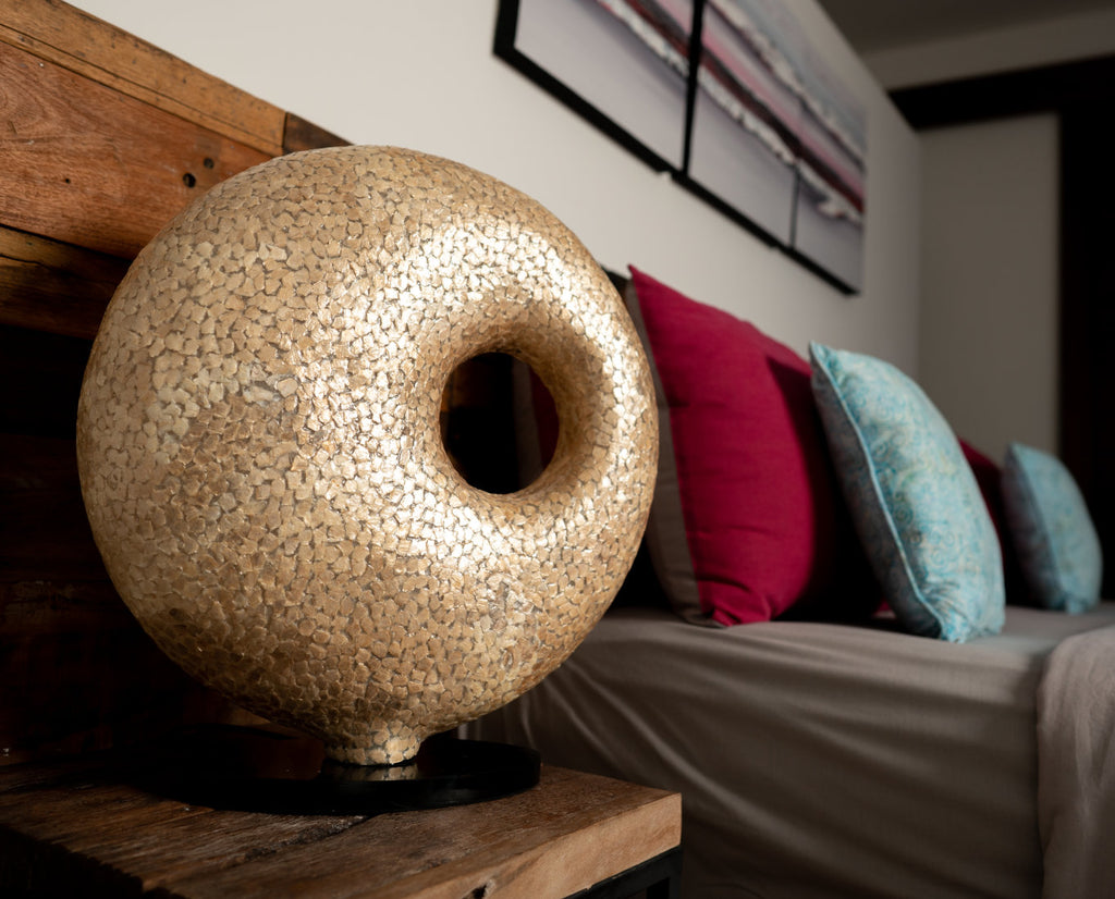 Floor Lamp Wangi Gold Doughnut in a bed room with wooden furniture. This is a handcrafted Light House Design Statement Lamp