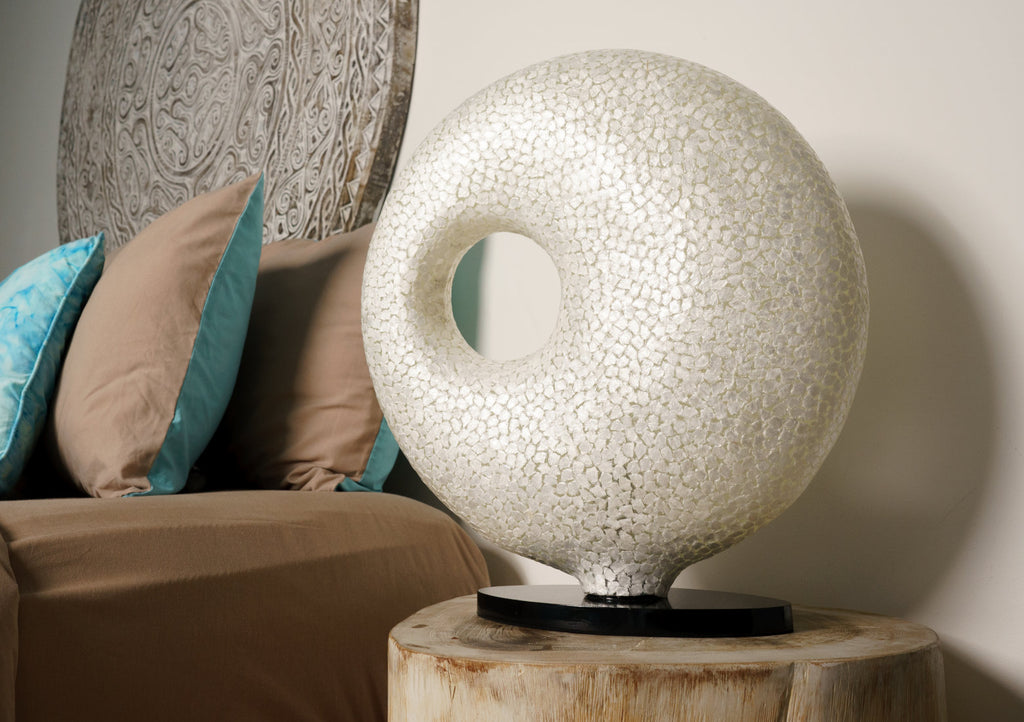 Table lamp "Wangi White Doughnut" on a bedside table in a bedroom. Light House Design Lighting - new in Singapore featuring unique designs 