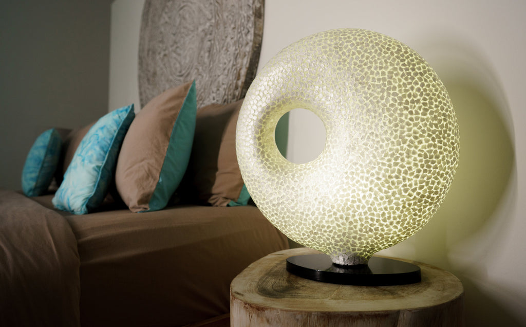 Table lamp "Wangi White Doughnut" on a bedside table in a bedroom. Light House Design Lighting - new in Singapore featuring unique designs 