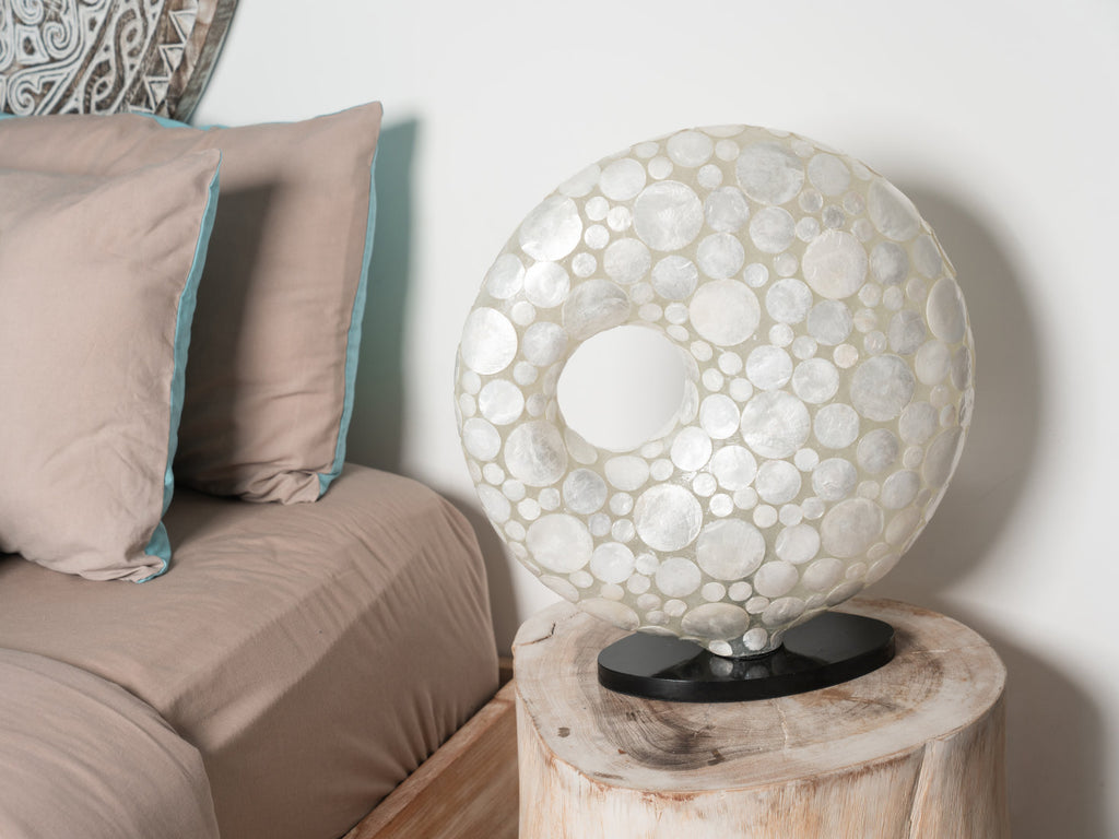 Beautiful doughnut table lamp in White coin design on a bedside table. The doughnut can not only be used in bed rooms. 