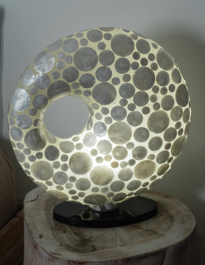 Beautiful doughnut table lamp in White coin design on a bedside table. The doughnut can not only be used in bed rooms. 