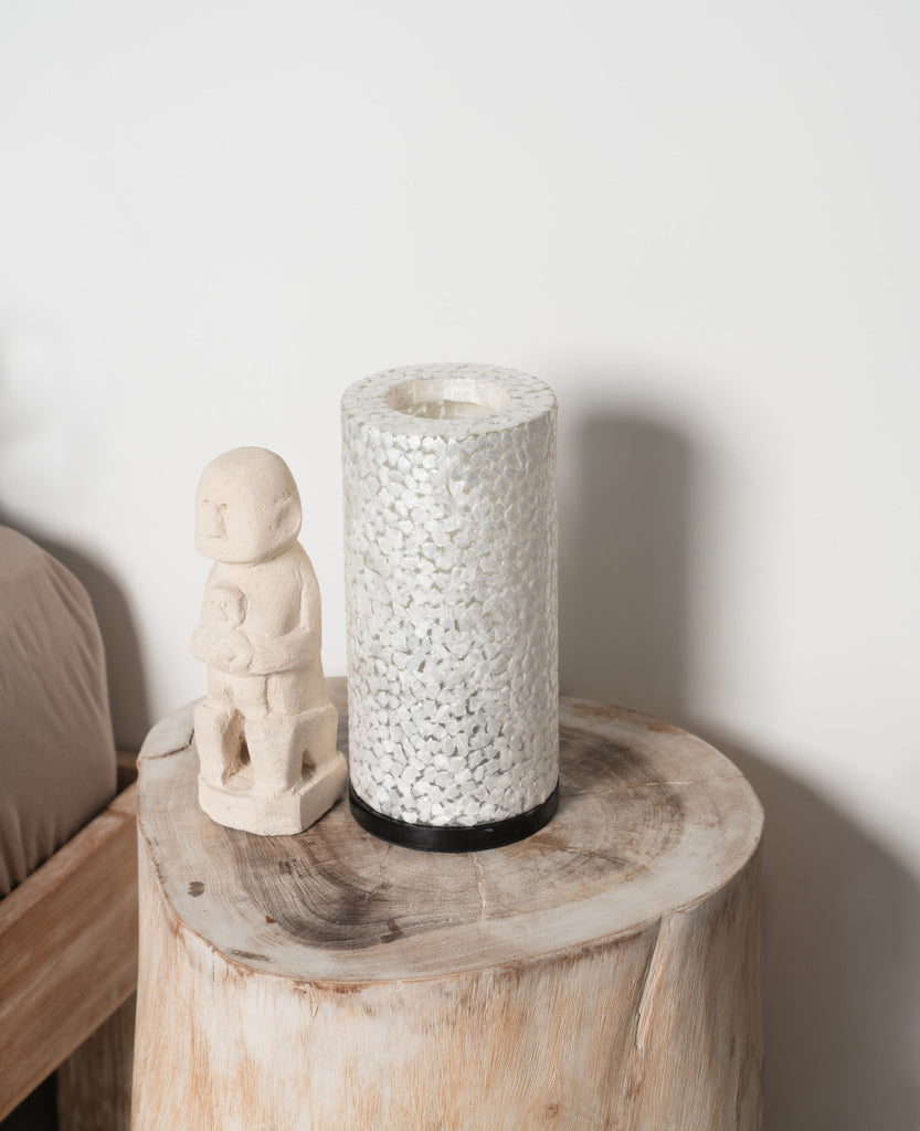 Decorative Table Lamp Wangi White on a bedside table next to a bed in a bedroom next to a small statue