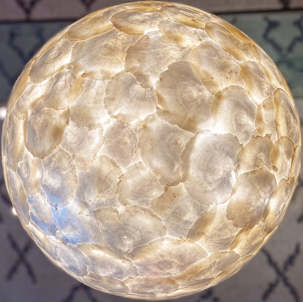 Sphere table lamp which is used as a bedside lamp in a bedroom. 