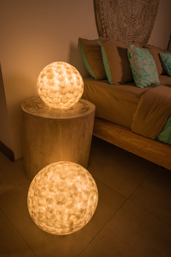 Sphere table lamp which is used as a bedside lamp in a bedroom. 