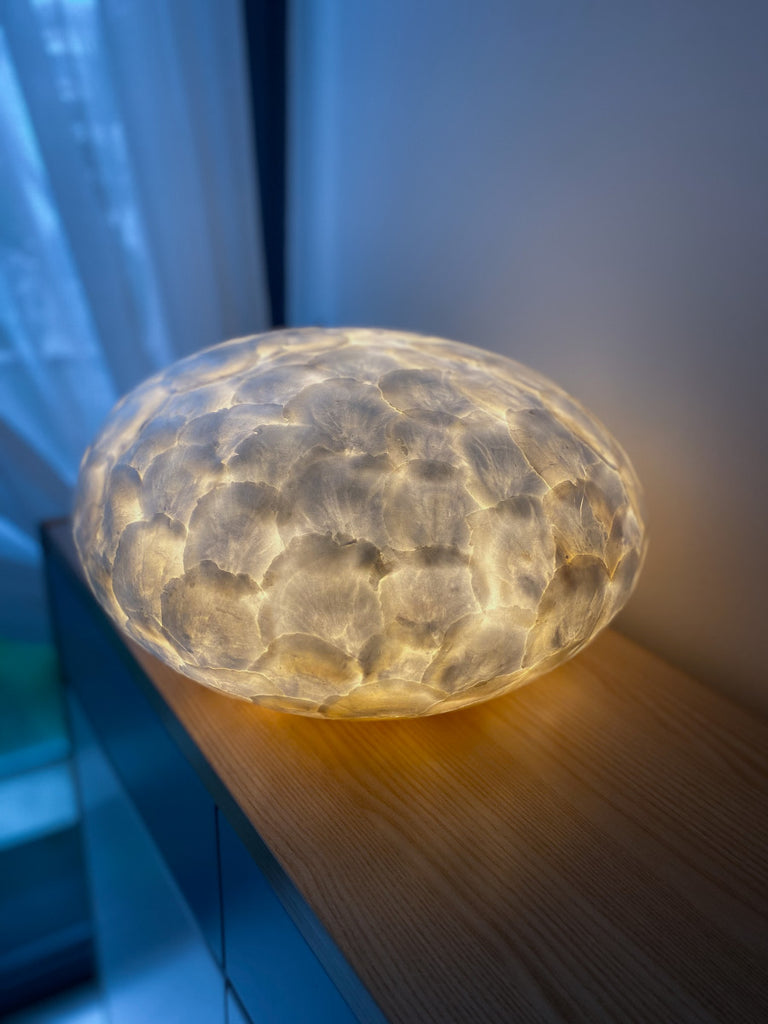 Table Lamp full shell UFO in front of a mirror. Beautiful glowing effect.