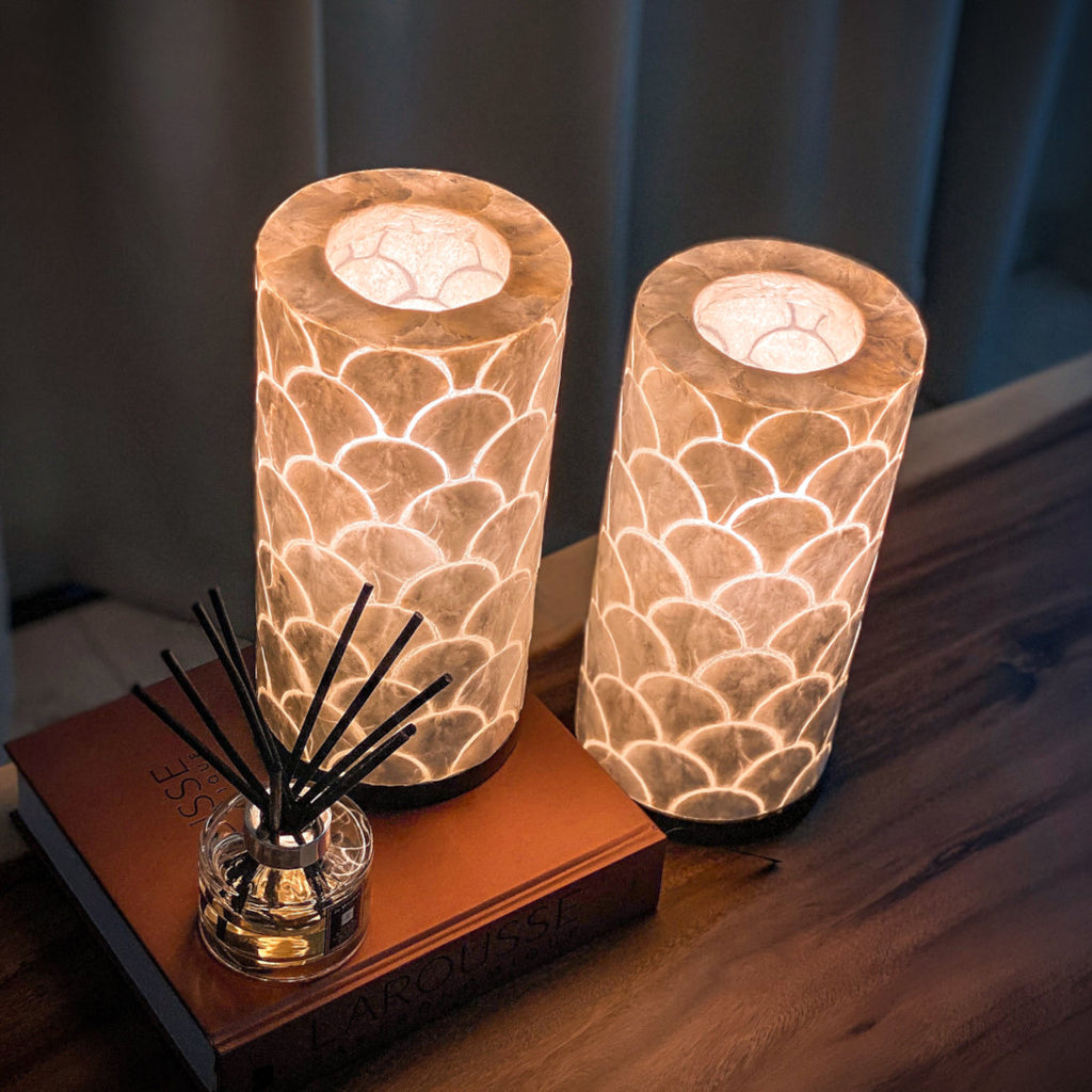 A set of 2 Kipas table lamps on a table in a living room