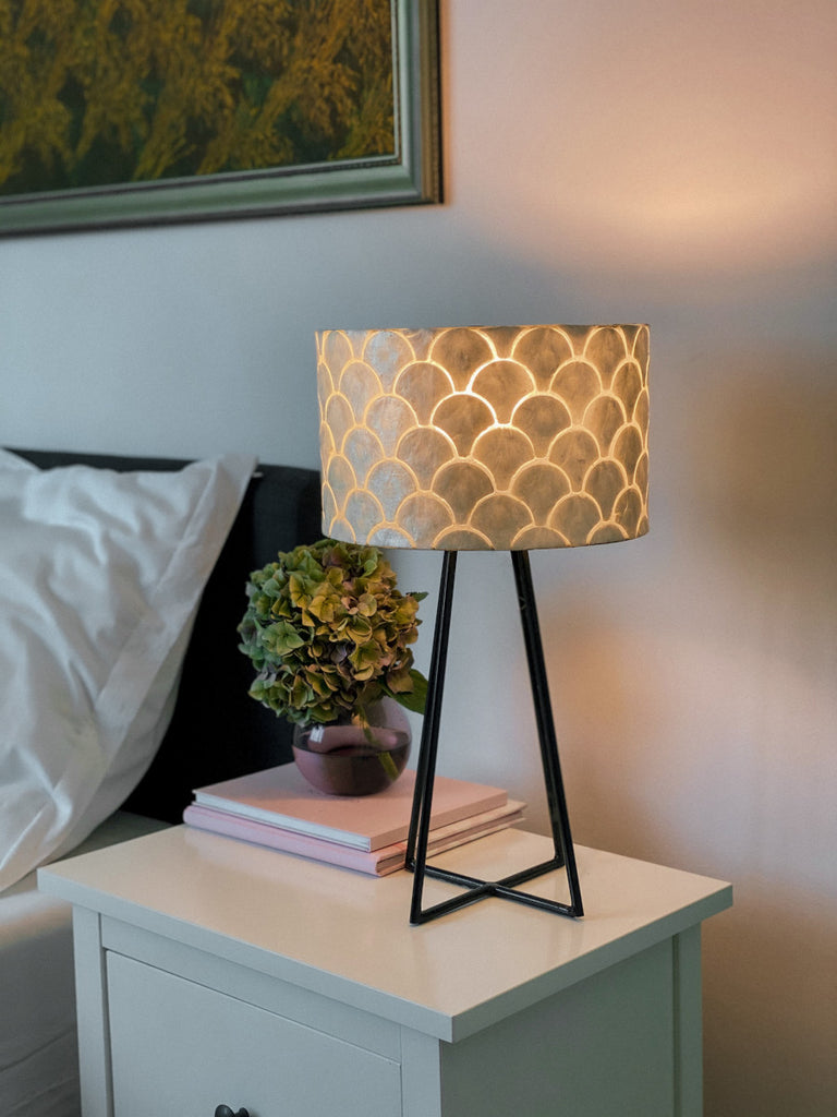 Table Lamp Kipas Quadropod standing on a bedside table in a bedroom next to the bed