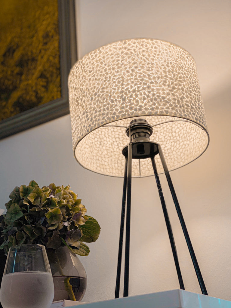 Table Lamp with shade standing on a bedside table in the bedroom