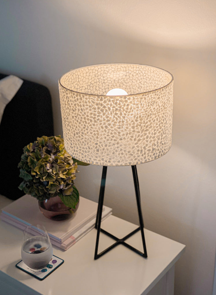 Table Lamp with shade standing on a bedside table in the bedroom