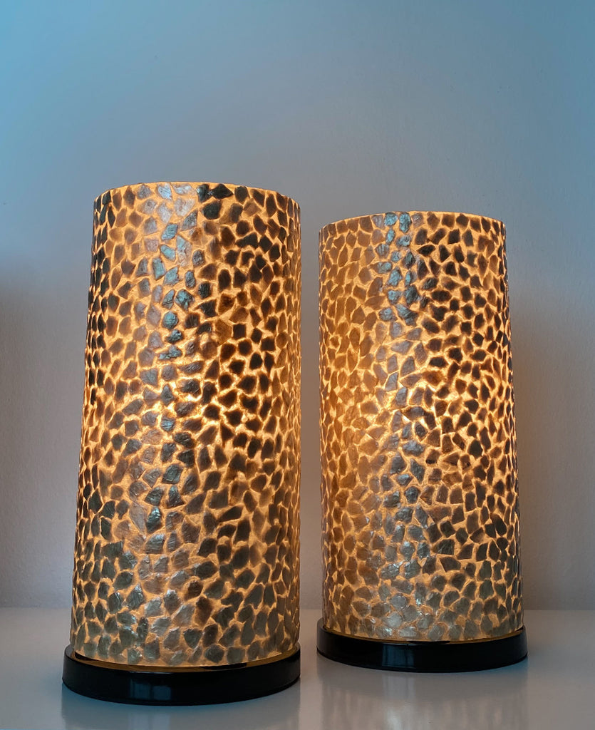 Handcrafted Mini Cylinder set of 2 is used as bedside table lamp on this picture next to a wooden bed in a bedroom